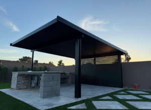 An outdoor kitchen and patio cover under construction by Az Sun Covers, showcasing quality work in Glendale, AZ.
