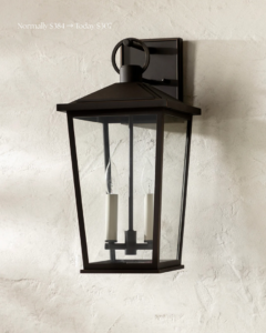 A dark bronze outdoor lantern light fixture mounted on a textured wall, representing exterior lighting services by Wiersma Homes in Knoxville, TN.