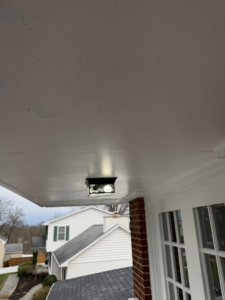A newly installed outdoor light fixture on a porch ceiling by HandyWorx Home Services LLC in Kenna, WV.