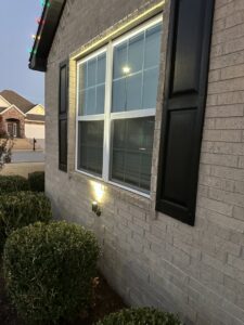 An outdoor light fixture installed on a brick house by I Know A Guy Handyman Service in Cottage Grove, MN.