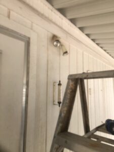 A ladder positioned next to a house wall for outdoor light fixture repair or replacement by Mancusi Home Maintenance in Boulder City, NV.