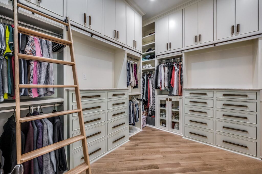 An outdoor living space featuring a covered patio, outdoor kitchen, and swimming pool by DFW Improved in Plano, TX.