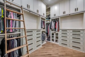 An outdoor living space featuring a covered patio, outdoor kitchen, and swimming pool by DFW Improved in Plano, TX.