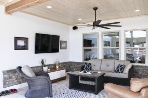 An outdoor living space with a newly installed ceiling fan and wall-mounted TV by Prestige Remodeling Solutions in Jackson, TN.