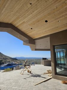 An outdoor patio with a newly installed wooden ceiling and construction equipment by Integrity Contracting in Cleveland, OH
