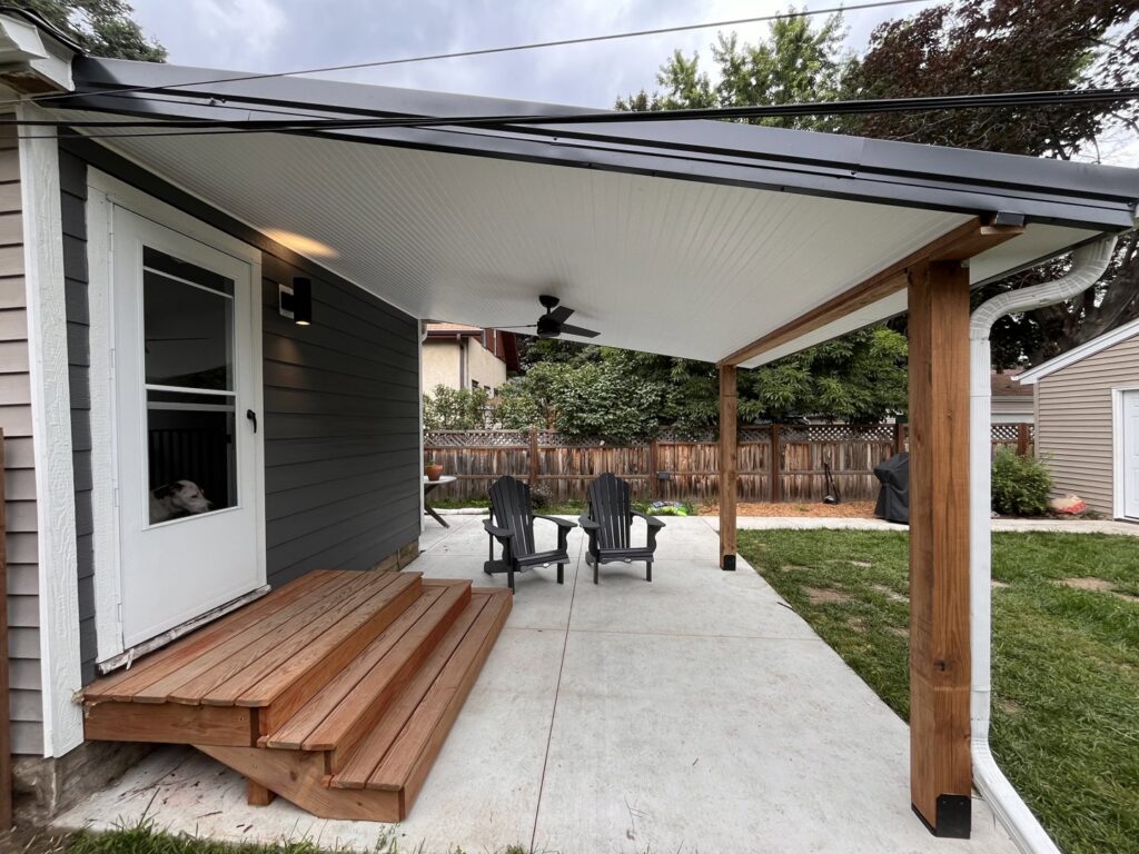 A newly constructed outdoor patio with a covered area, ceiling fan, and wooden steps, built by Inova Builds in Bloomington, MN.