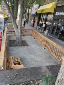 Outdoor patio area with new wooden fence construction and lumber by J & D Home Innovations in West Jordan, UT