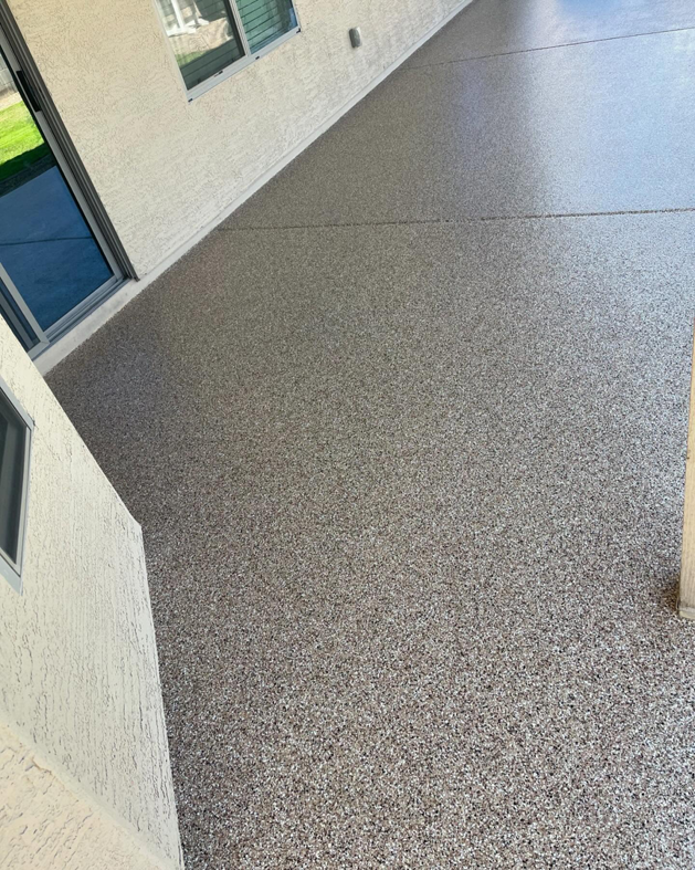 A durable and attractive speckled flake coating applied to an outdoor patio by Savage Coatings in Lakeland, FL.