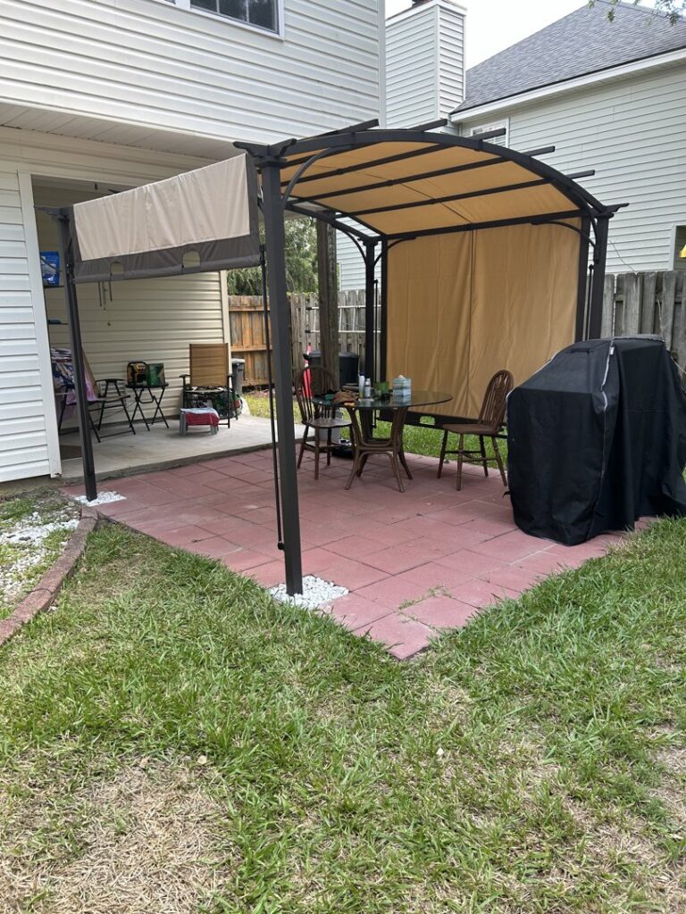 An assembled outdoor patio gazebo with a table and chairs, a service provided by Bull River Handyman in Savannah, GA.