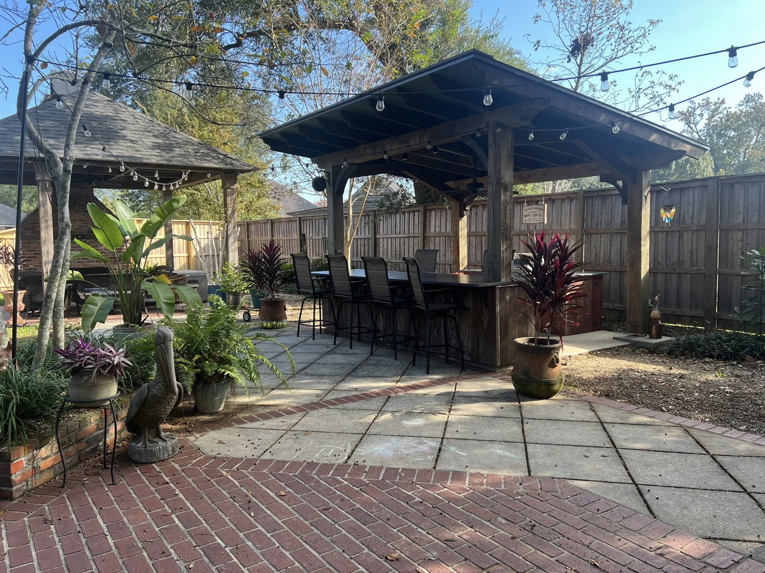An outdoor patio with a newly constructed gazebo and bar area by Ourso Renovations in Baton Rouge, LA
