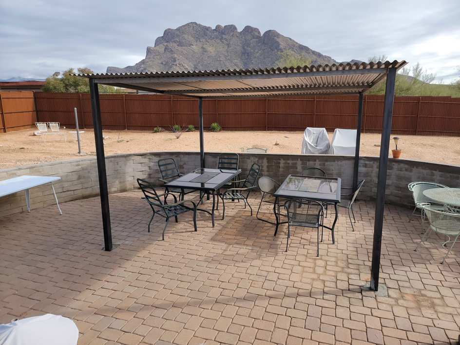 An outdoor patio featuring a newly installed metal pergola by Able Fence LLC in Tucson, AZ.