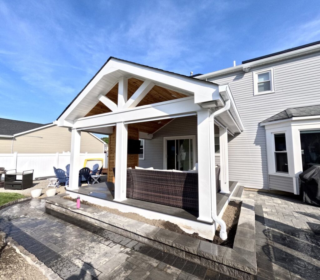 A newly constructed outdoor patio and pergola structure by Stanley Contracting in Whiting, NJ