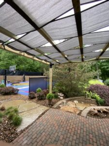An outdoor patio featuring a newly built pergola shade structure by ACE Roofing & Construction in Ruskin, FL
