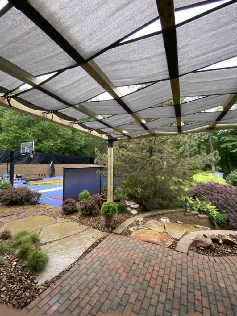 An outdoor patio featuring a newly built pergola shade structure by ACE Roofing & Construction in Ruskin, FL