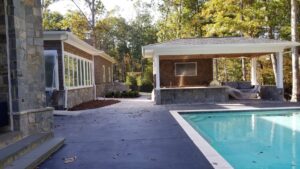 An outdoor pool area with a newly renovated covered patio structure by Albis Morales Painting LLC in Raleigh, NC.