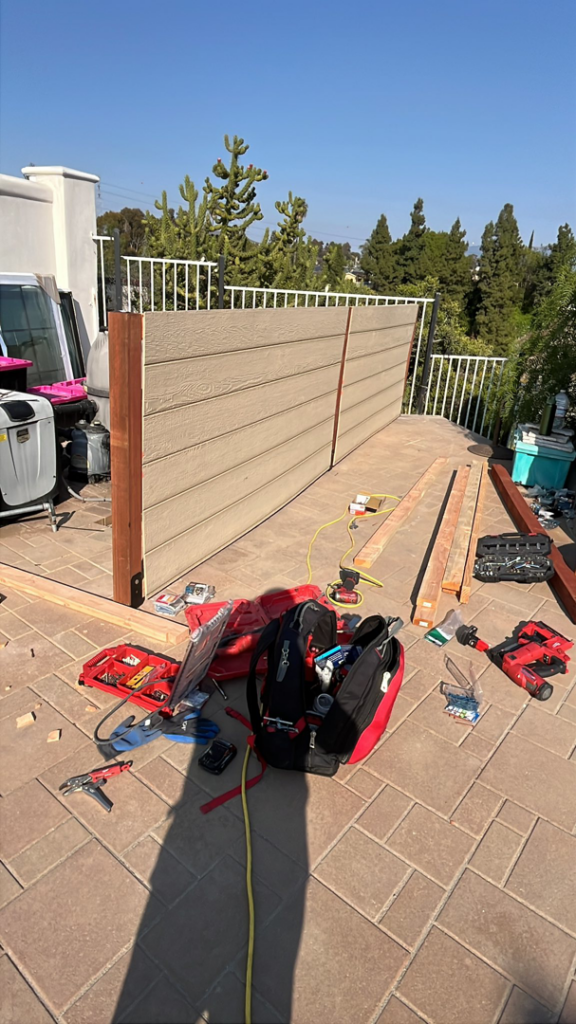Outdoor patio construction showing materials and tools for a new privacy screen by Pauda Handyman in San Diego, CA.