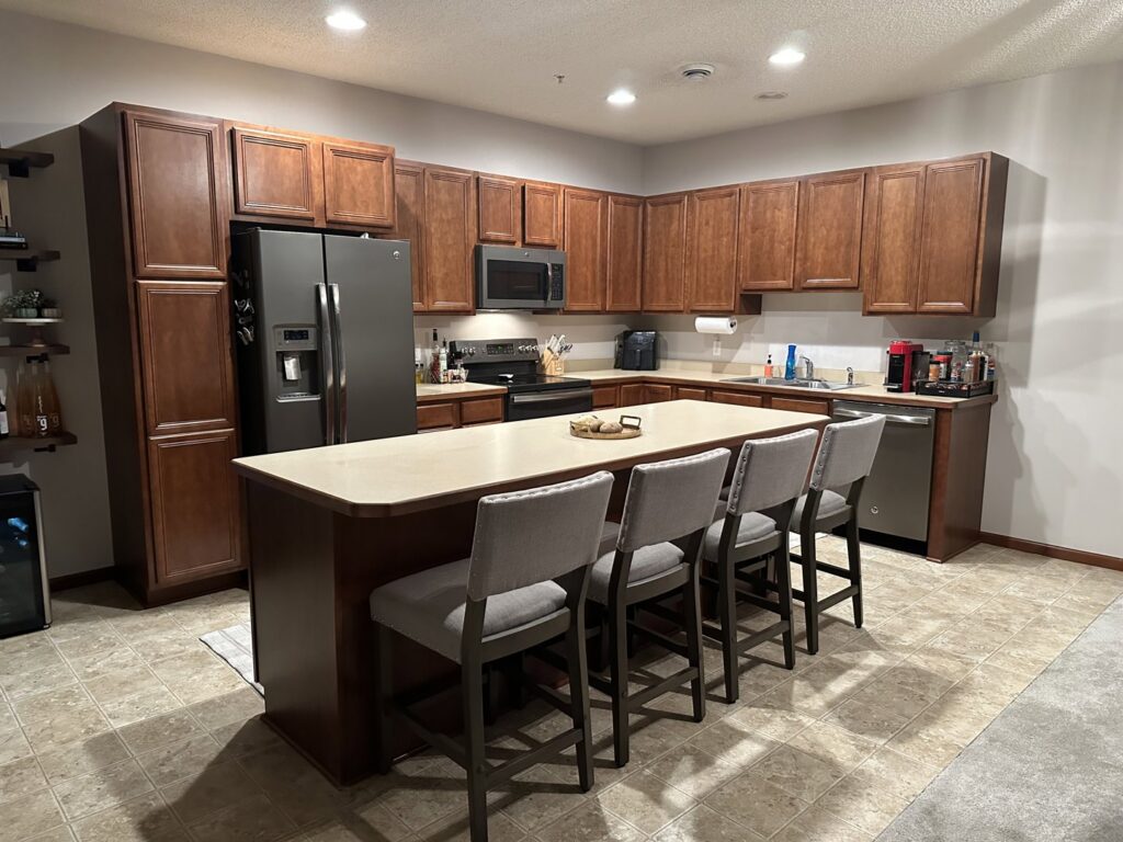 A worker installing decorative tiles on an outdoor patio by CSR Tile Construction LLC in Minneapolis, MN.