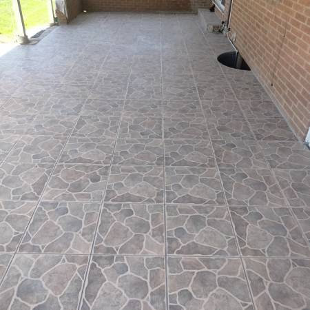 Outdoor patio with new tile installation by True Alchemy - Tile & Grout Restoration in Denver, CO.