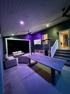 Outdoor patio with a mounted TV and ambient lighting installed by M&M Home Builders, LLC in Richmond, VA.
