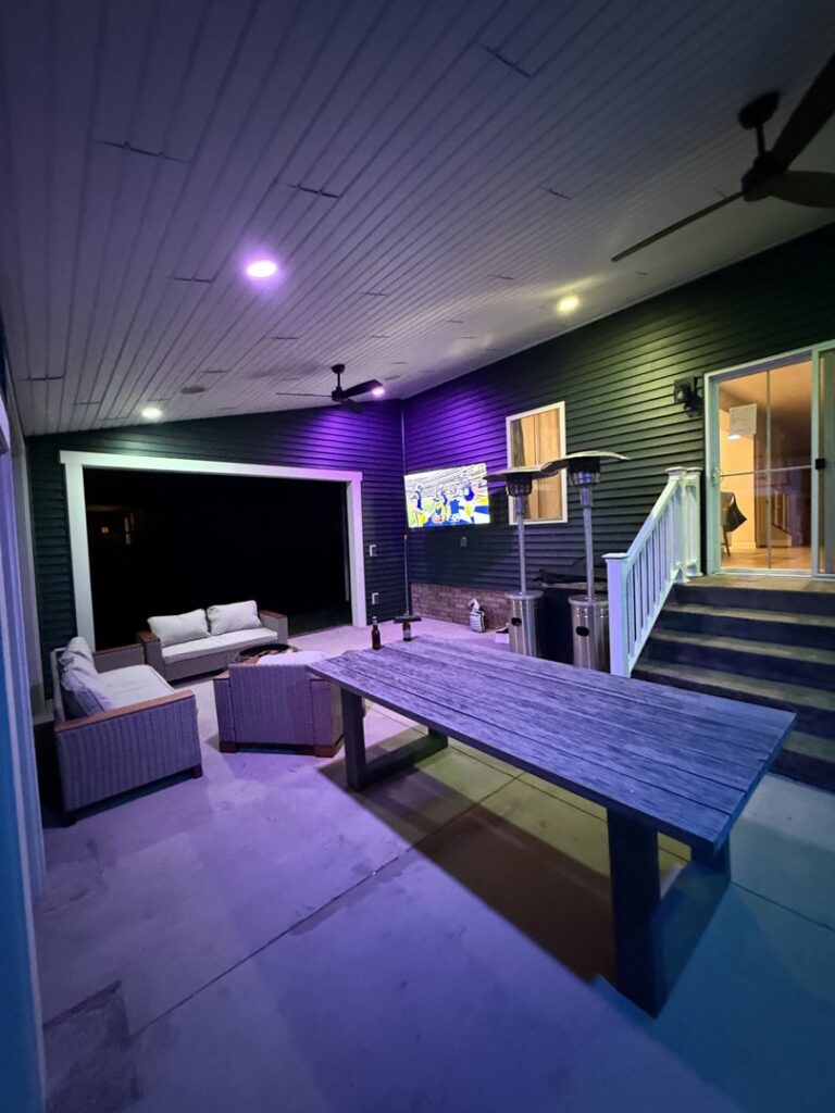 Outdoor patio with a mounted TV and ambient lighting installed by M&M Home Builders, LLC in Richmond, VA.