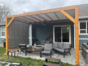 An outdoor patio featuring a newly constructed wooden pergola, a service provided by Forever Young Handyman Services in Boise, ID.