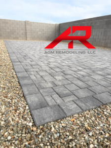 A newly installed outdoor paver patio with gravel borders, expertly completed by AGM Remodeling LLC in Scottsdale, AZ.