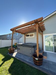 Outdoor wooden pergola construction over a hot tub by Panhandle Contracting Co. in Rathdrum, ID