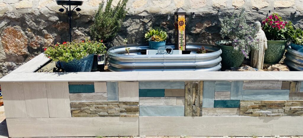 An outdoor planter box with decorative tile and stone accents, a project by Lay's Remodeling LLC in El Paso, TX