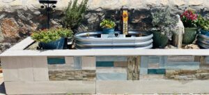 An outdoor planter box with decorative tile and stone accents, a project by Lay's Remodeling LLC in El Paso, TX