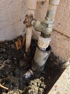 An outdoor plumbing issue with a broken pipe and old spigot, ready for repair by Bakoboy Enterprise Inc in Bakersfield, CA.