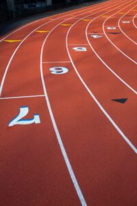 A close-up view of the lanes and numbers on an outdoor running track installed by Abacus Sports Installations, Ltd in Lancaster, PA