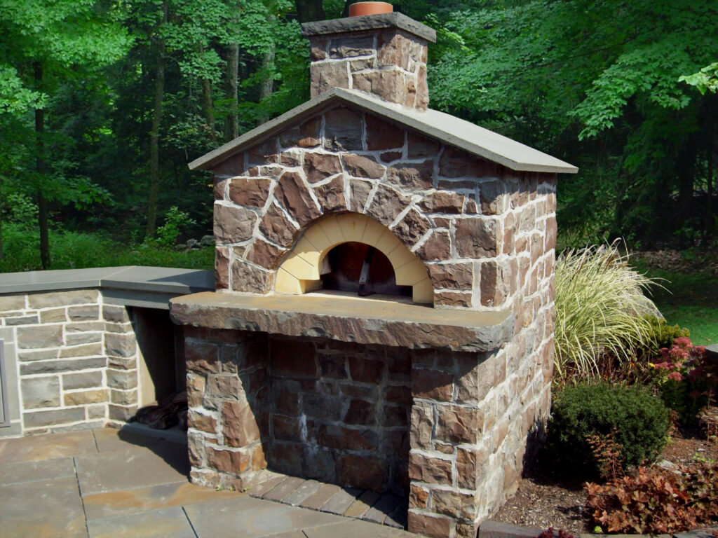 A beautifully constructed outdoor stone pizza oven, a project by Adam Ross Cut Stone in Albany, NY.