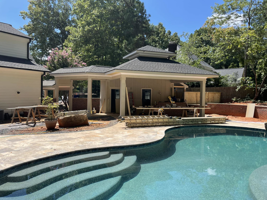 An outdoor structure under construction next to a swimming pool by Jayco Construction Company in Wake Forest, NC