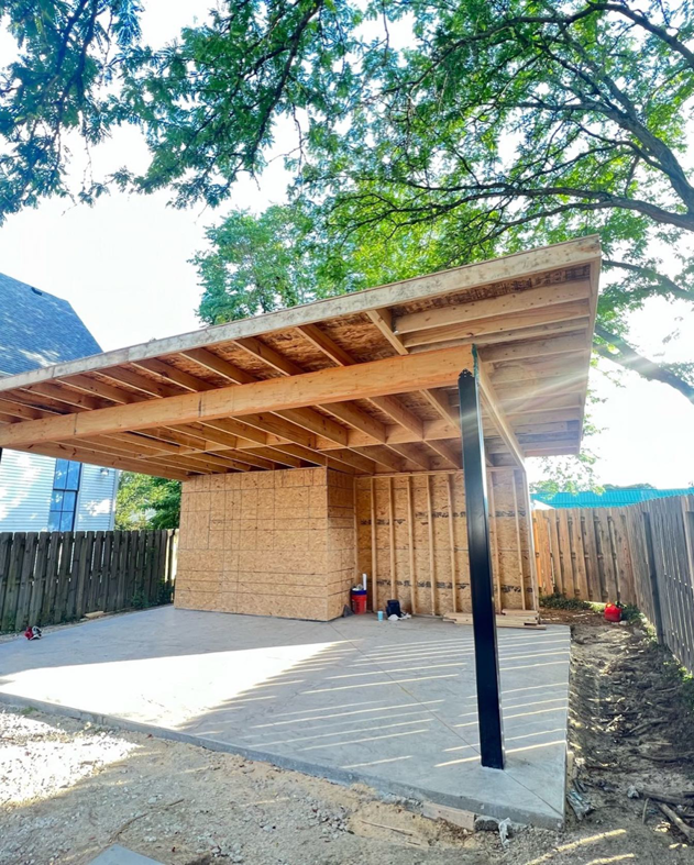 An outdoor structure under construction with wood framing and a concrete slab by Smith Construction Services in Cincinnati, OH
