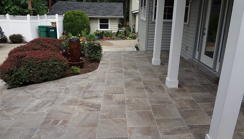 A newly installed outdoor tile patio by Rescue Landscaping and Outdoor Living in St. Louis, MO