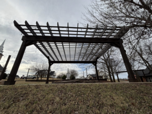 An outdoor wooden pergola structure installed by Oklahoma Painting & Construction in Oklahoma City, OK.
