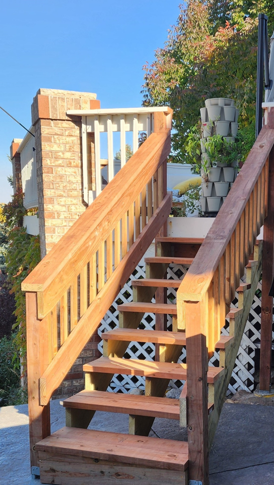 Newly built or repaired outdoor wooden stairs with railings by Peak2Peak Connect Handyman Services LLC in Arvada, CO.