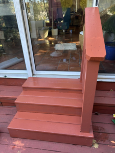 Freshly painted outdoor wooden steps and railing by Ingram Painting and Renovation in Birmingham, AL.