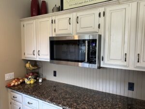 An over-the-range microwave professionally installed above a kitchen countertop by R&J Handyman Services LLC in Warwick, RI.