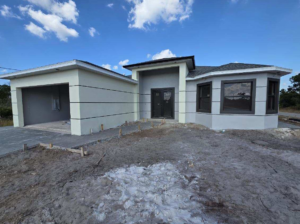 Overall front view of a new house under construction by C.A Tano Construction & Appliances Cgc1531664 in Cape Coral, FL.