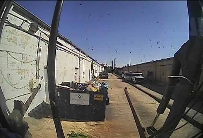 An overflowing commercial dumpster filled with trash, showing a general junk removal need by Waste Connections in Houston, TX.