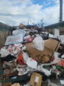 Overflowing dumpster with household and commercial junk, removed by P and P Junk Removal and Demolition in Norfolk, VA.