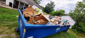An overflowing dumpster filled with trash and debris, indicating a large junk removal job by JUNK BRO'S in Hickory, NC.