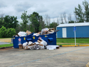 Overflowing commercial dumpsters filled with trash and boxes, a junk removal need for Odees_hauling_services, Indianapolis, IN.