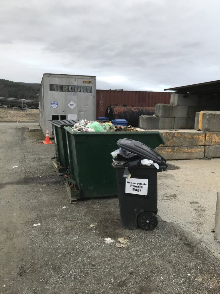 Overflowing dumpsters filled with various types of junk and waste at Windham Solid Waste Management District in Brattleboro, VT.
