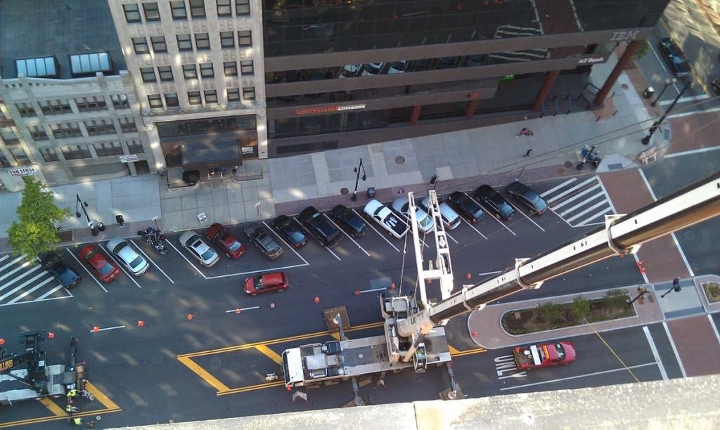 An overhead view of a large crane set up on a city street for a construction project by Mullins Rigging in Green Island, NY