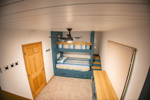 An overhead view of a room featuring custom bunk beds, a ceiling fan, and a door installed by An Extra Hand in Indianapolis, IN.