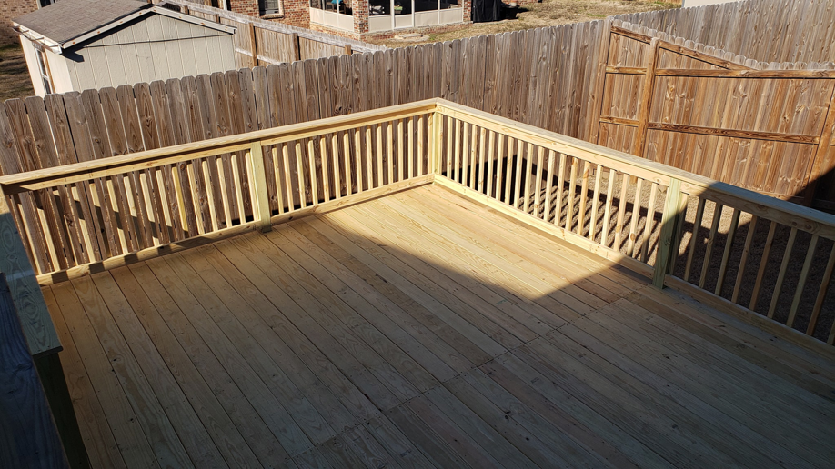 An overhead view of a spacious, newly constructed wooden deck, built by Wilcox Handyman Services in Conway, AR.