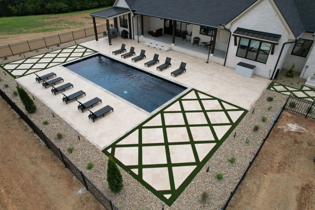 An overhead view showcasing a complete pool and patio installation with integrated landscaping by Southern Pool Solutions in Knoxville, TN.