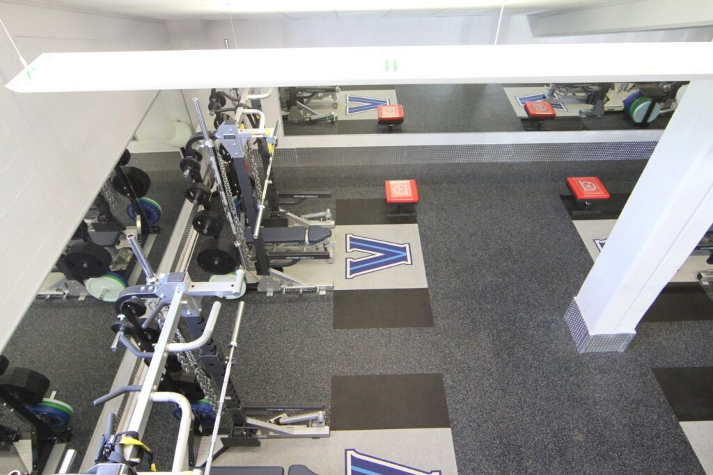 An overhead view of a fully equipped weight room and gym facility, a project by Abacus Sports Installations, Ltd in Lancaster, PA.